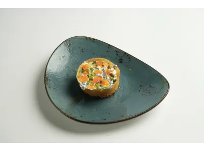Baby Malai Ghewar topped with silver foil, dry fruits, and saffron strands, showcasing a festive and rich Indian sweet.
