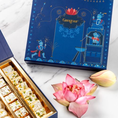 Gangour Angan mithai box with festive blue artwork, lotus flower, and Indian sweets.