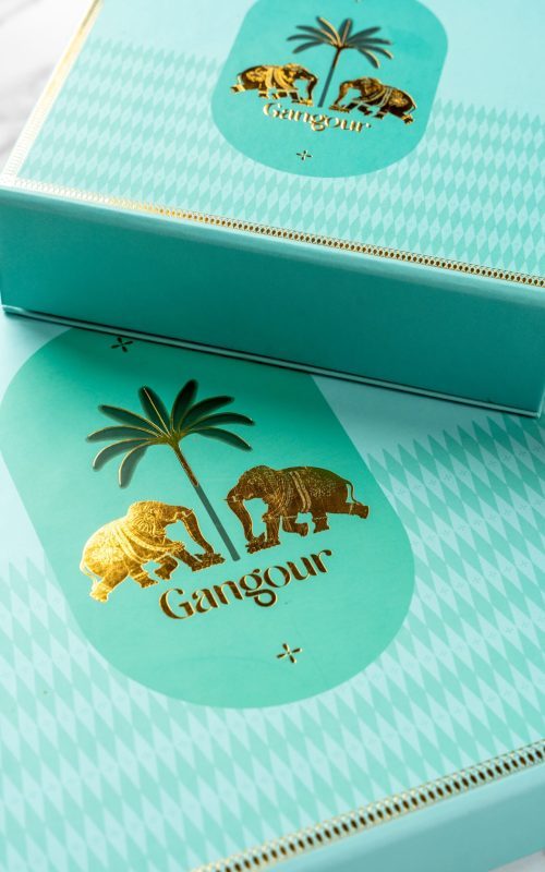 Turquoise Gangour Aranya mithai box with golden elephant and palm tree design
