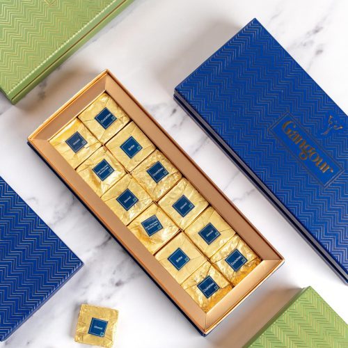 Luxury box of 12 gold-wrapped chocolates in elegant blue and green packaging