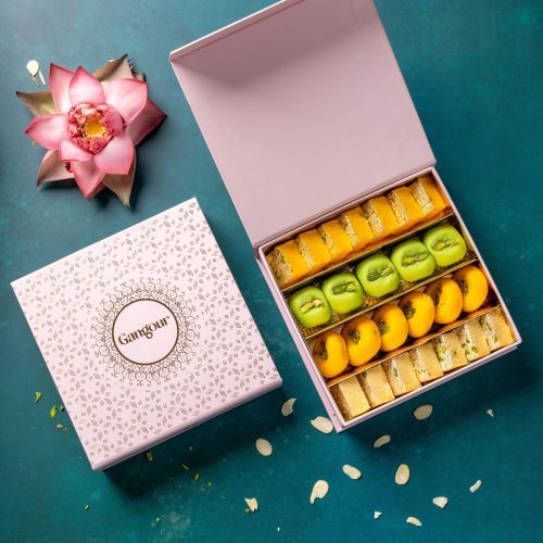 Festive box of assorted Indian sweets with peda, barfi, and rolls, elegantly packed