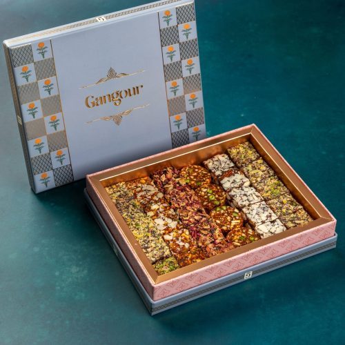 Elegant gift box with assorted dry fruit sweets in decorative rows