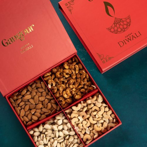 Red Diwali gift box with four compartments filled with almonds, cashews, pistachios, and masala cashews