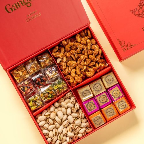 Red Diwali gift box with masala cashews, pistachios, assorted sweets, and colorful snack packs