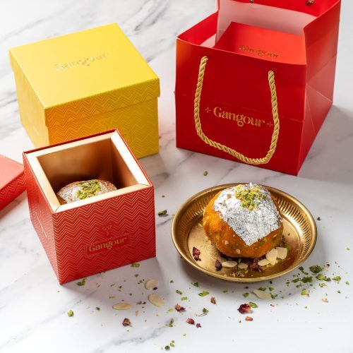Single large silver-coated laddu in a decorative red box with Gangour branding